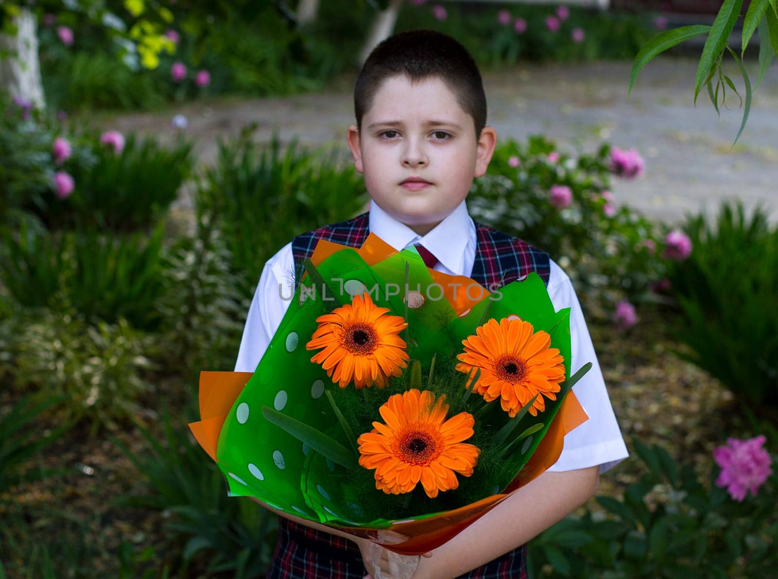 the school student with a beautiful bouquet of flowers, the front view