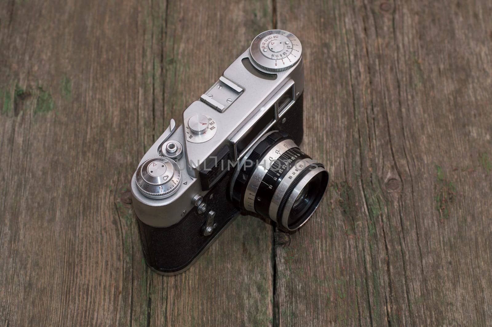 retro the camera on a wooden table a side view