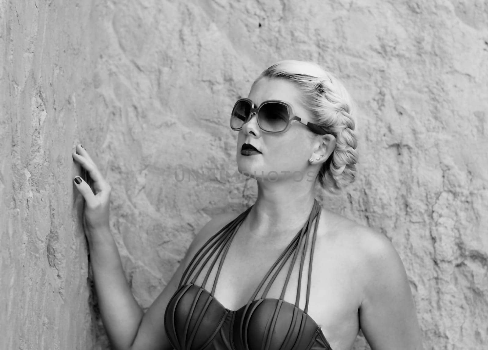 portrait of the beautiful woman at the rock, the black-and-white photo