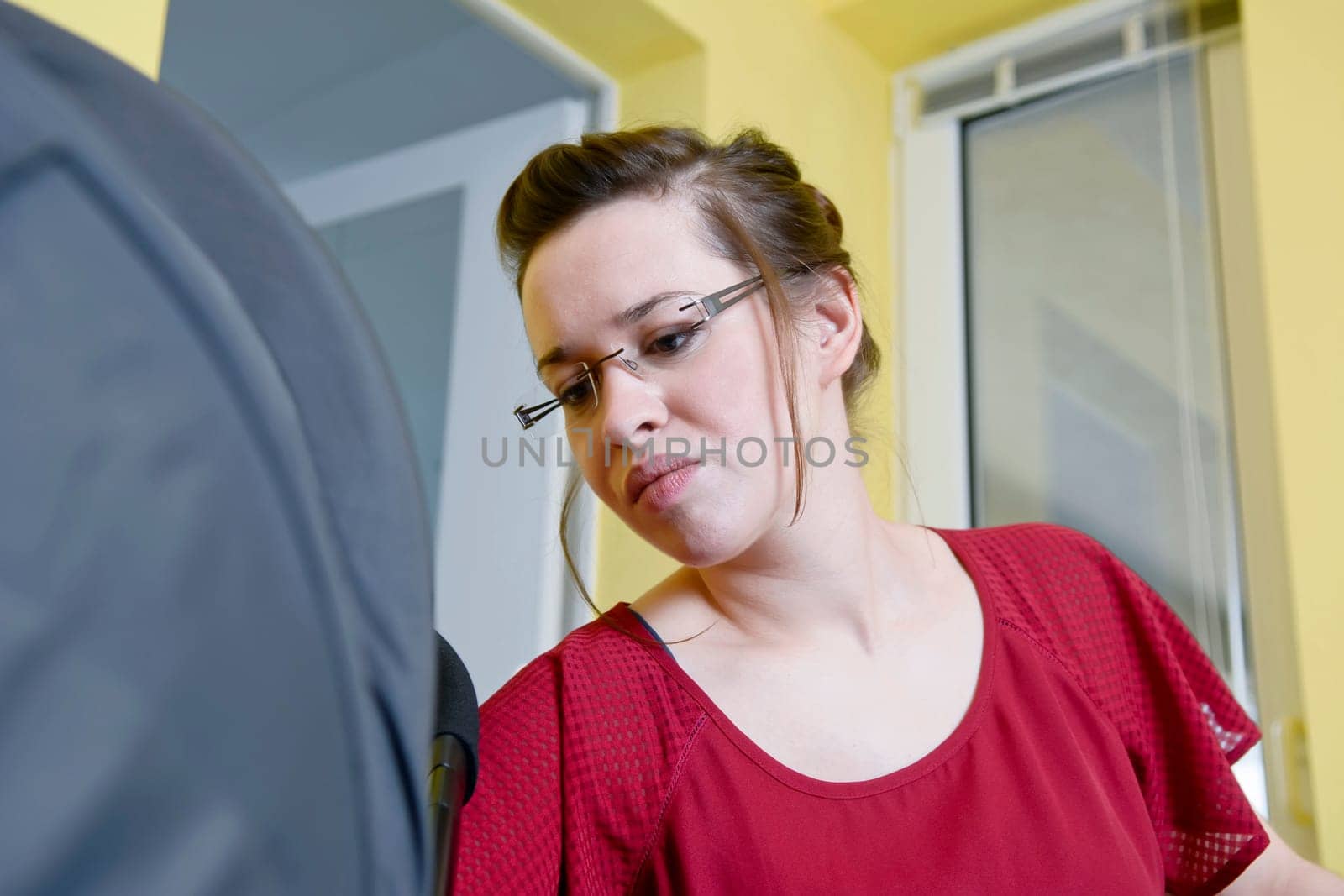 young mother looks into stroller