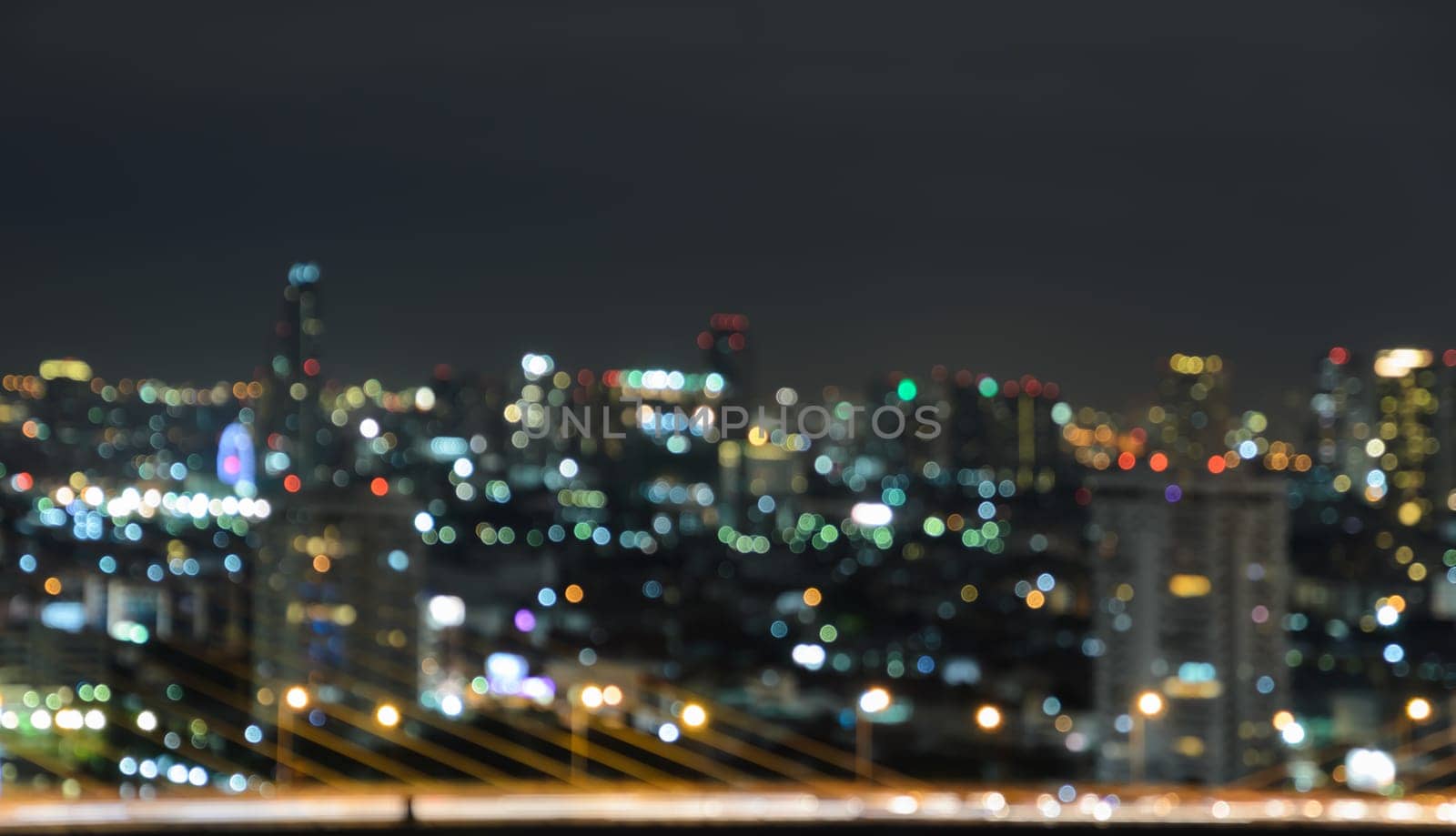 Colorful blurred skyscrapers with city bokeh lights illuminated at twilight