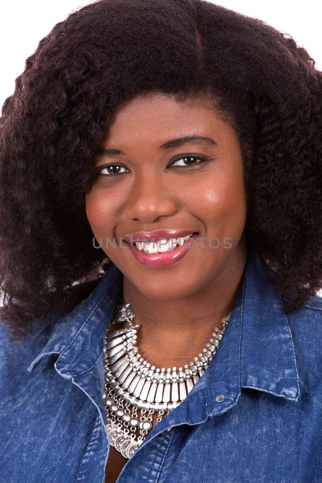 beautiful young black woman is wearing jean dress on white background
