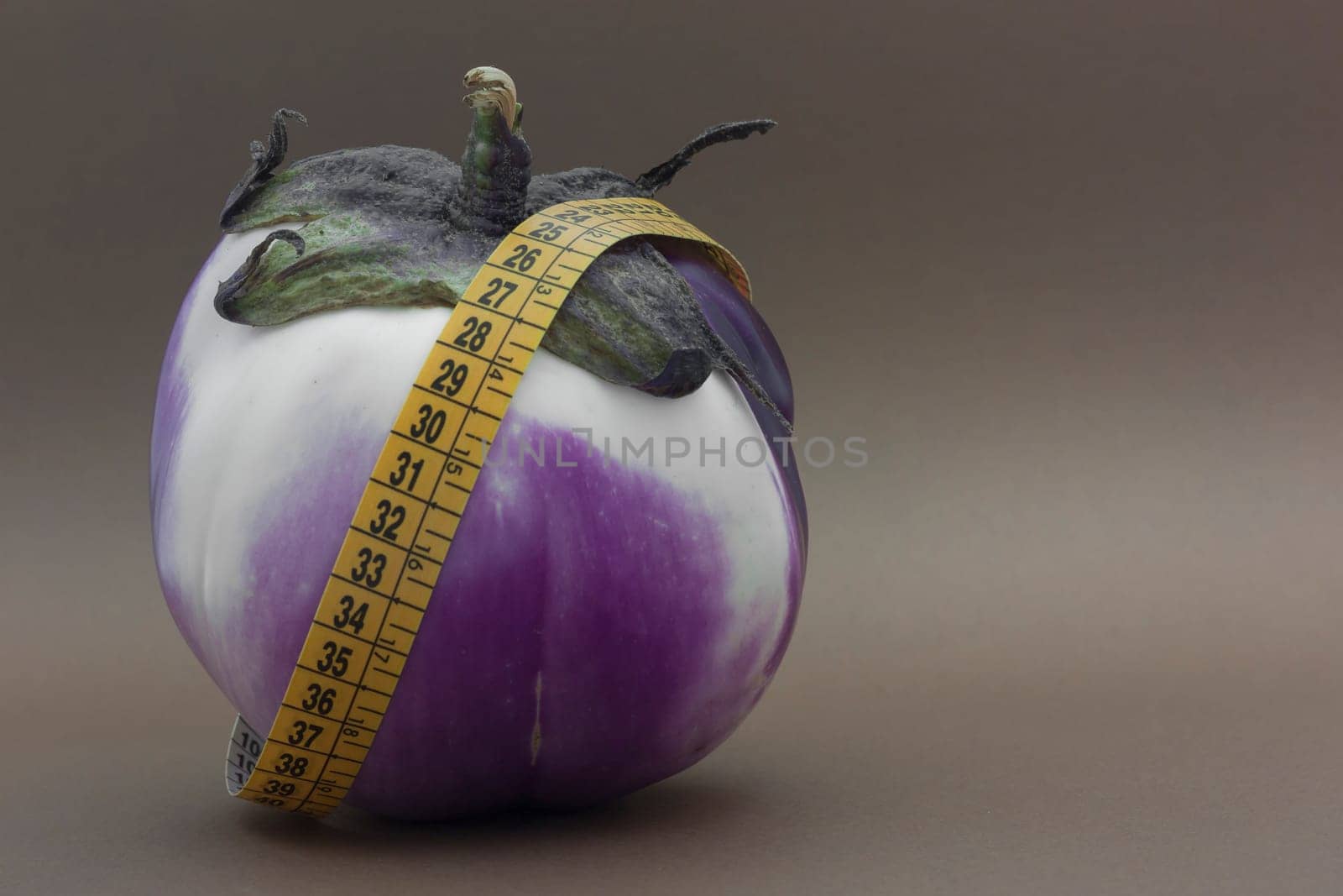 Fresh Ripe eggplant isolated on brown background to understand a concept of healthy eating