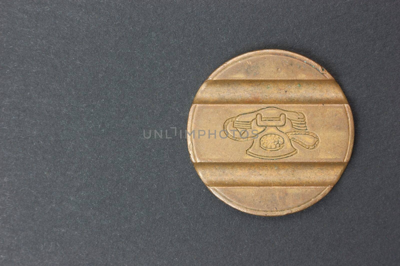Ancient coin Italian telephone on a black background