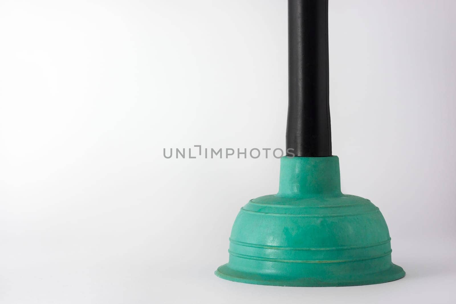 Rubber plunger with plastic handles on a dark background
