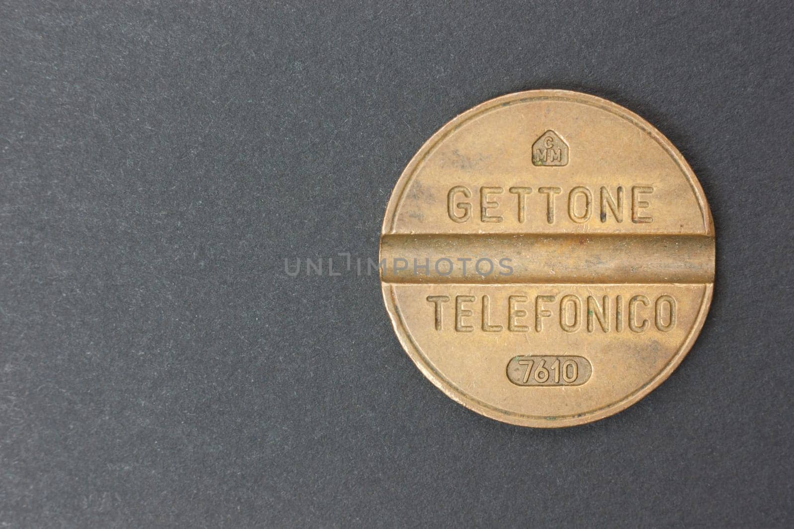 Italian telephone token on a black background