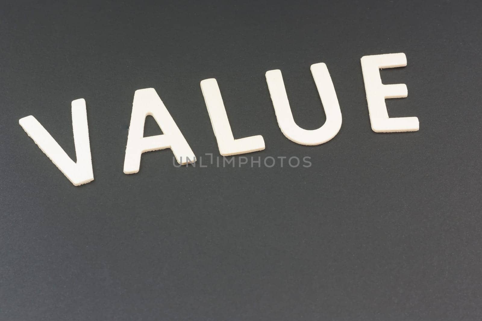 The value written with wooden urn on a black background