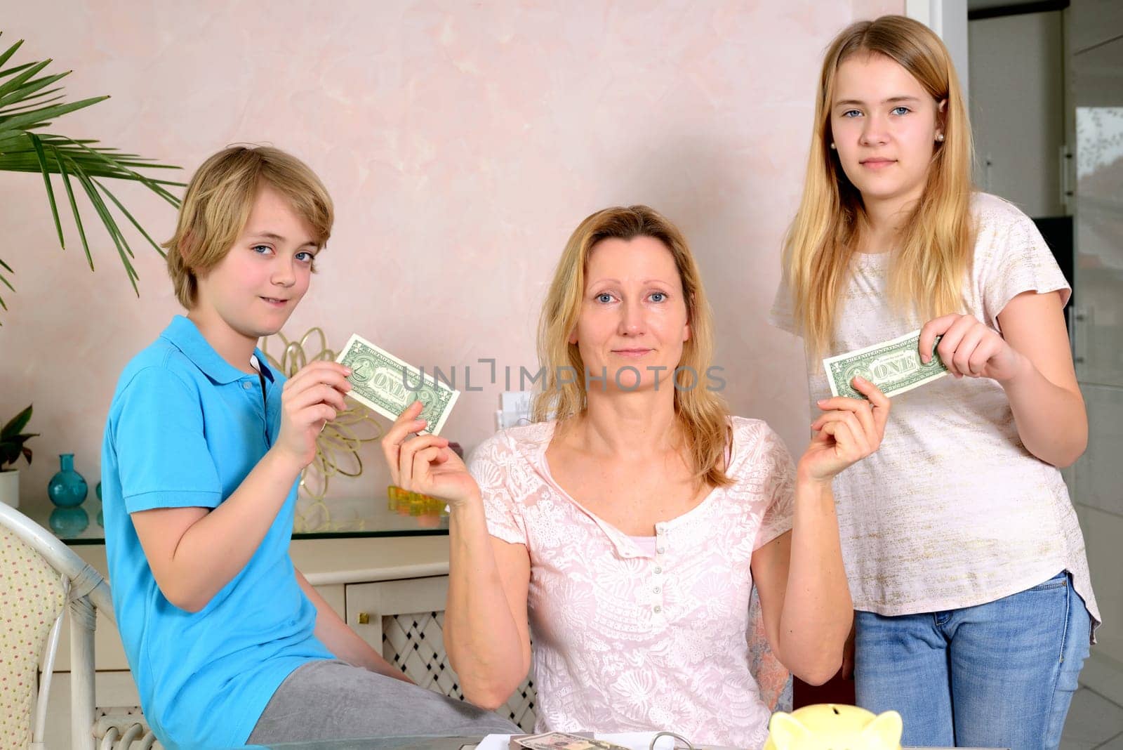 blond mother giving her children pocket money