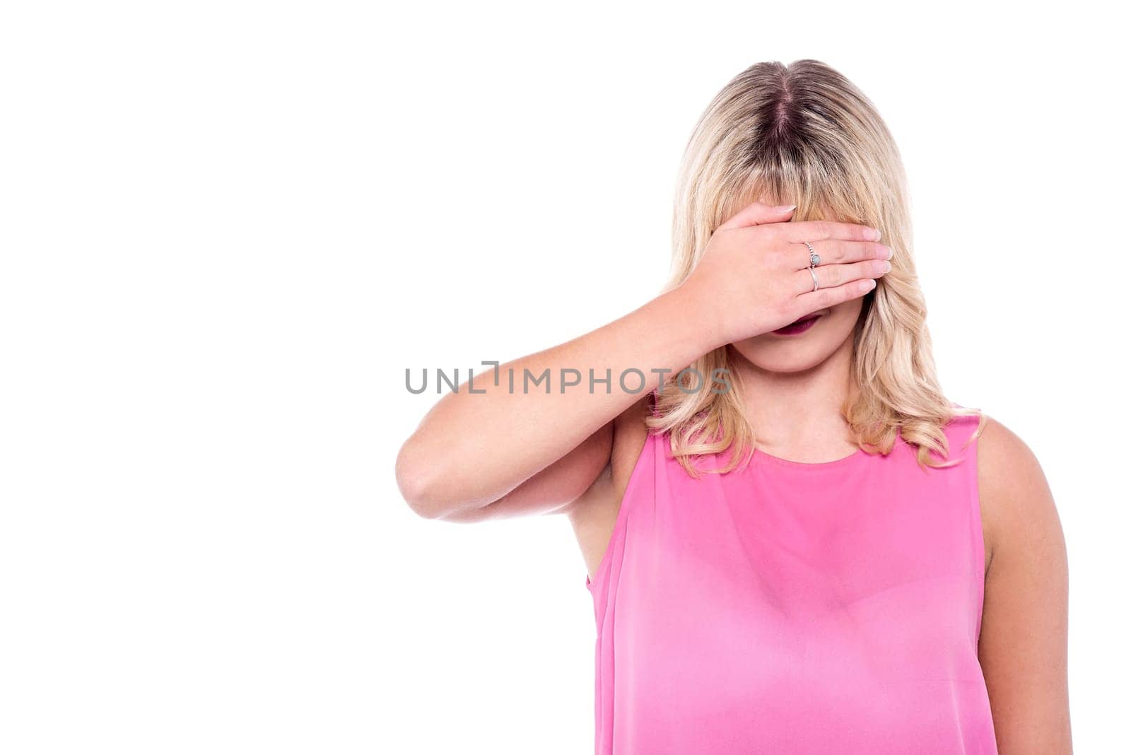 Woman covering her face with hand