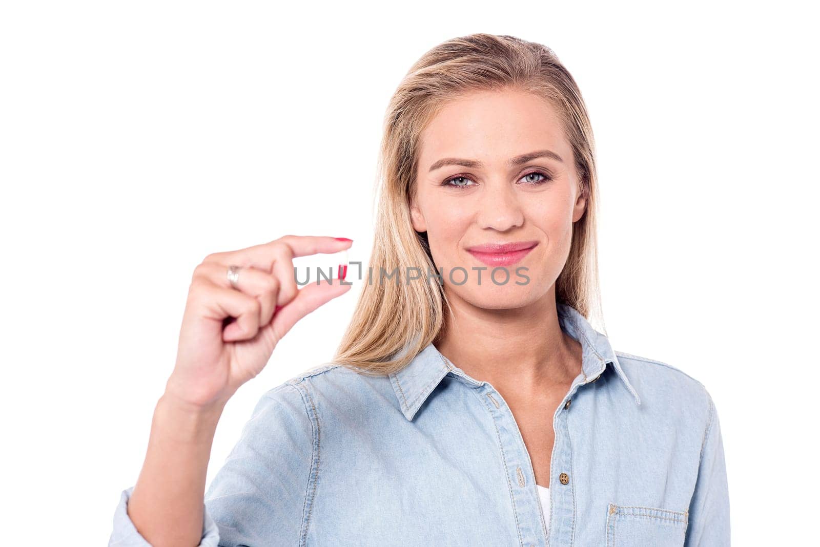 Young beautiful woman holding capsule