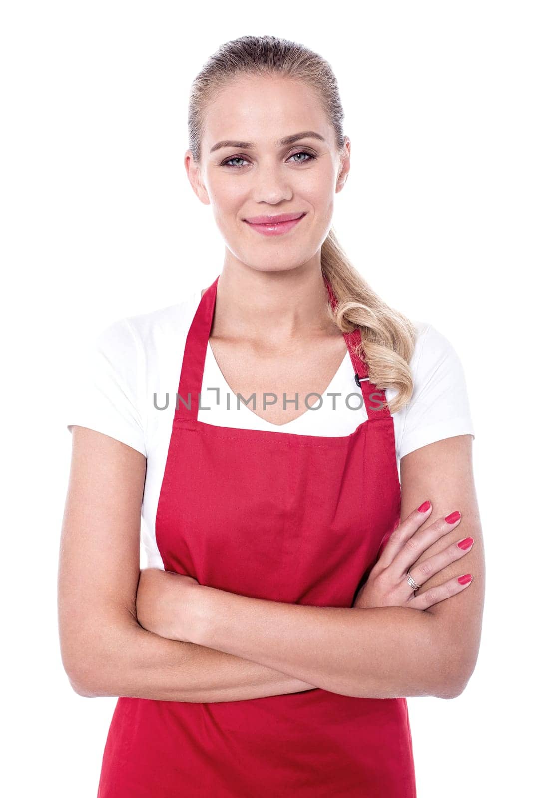 Attractive chef in apron posing with folded arms