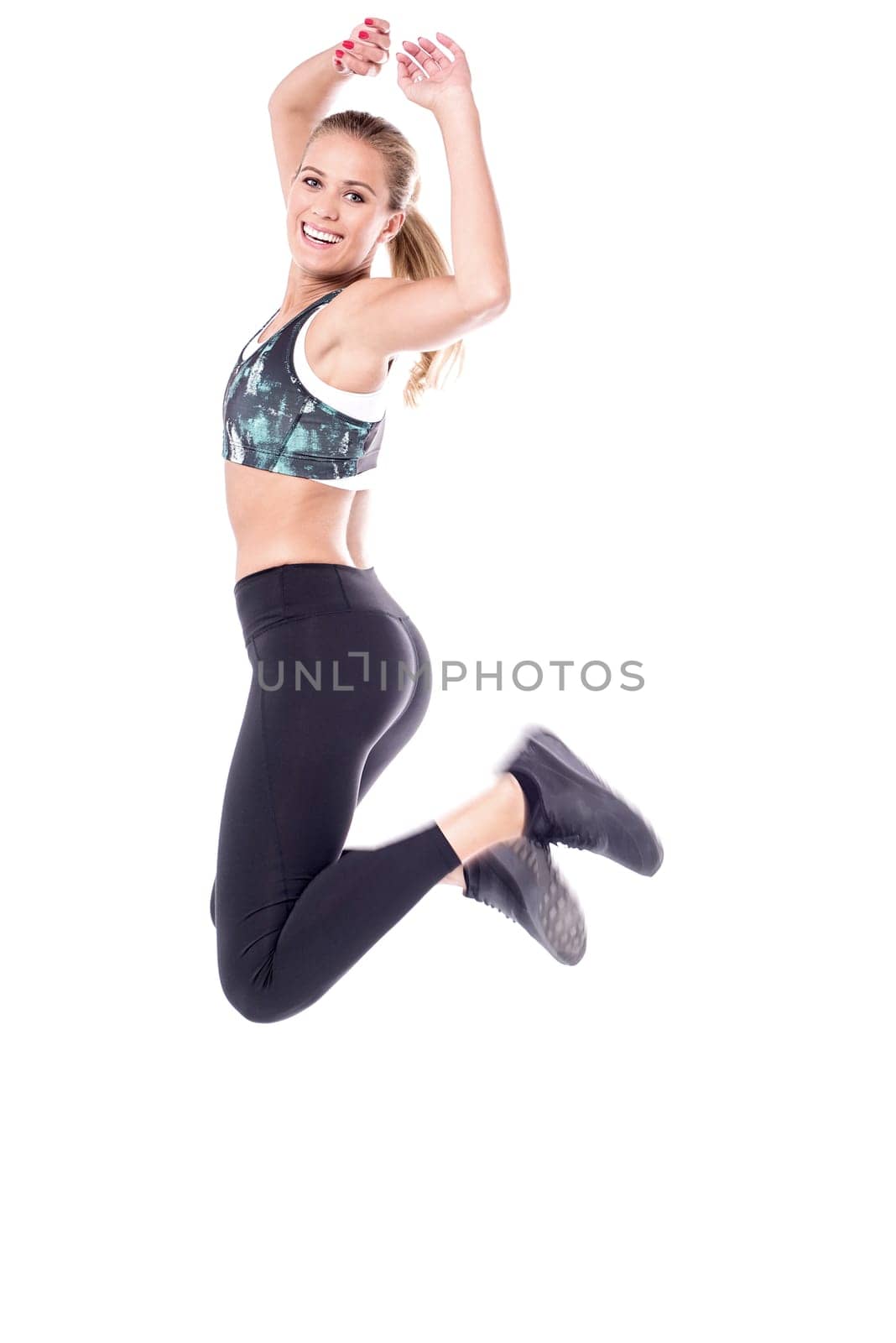 Fitness woman jumping high in air