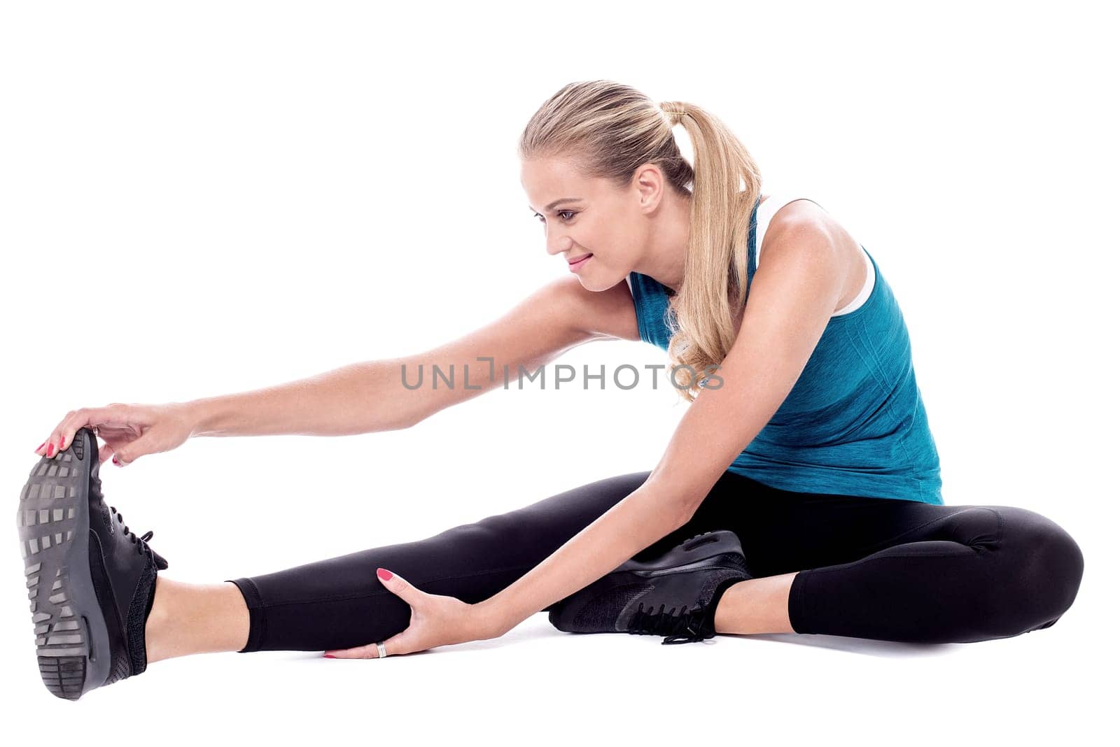 Gym trainer exercising, studio shot.