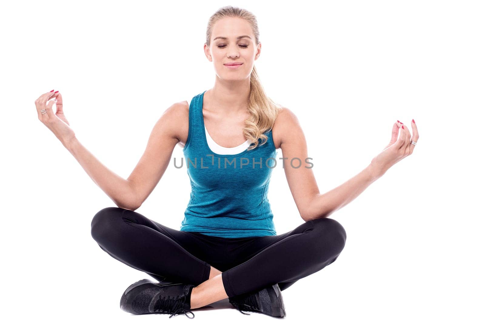 Beautiful woman meditating in lotus pose