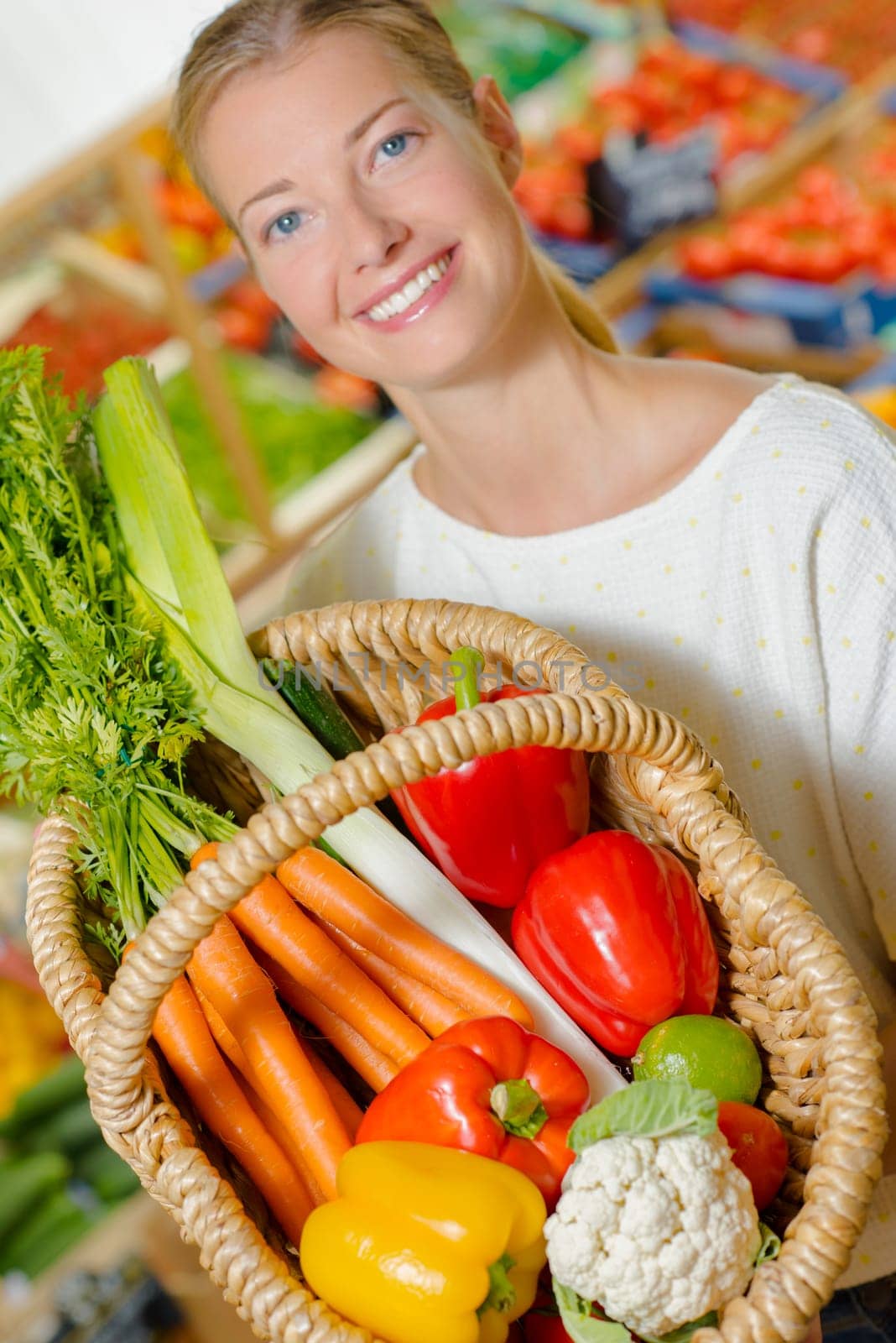 Woman holding up her shopping basket
