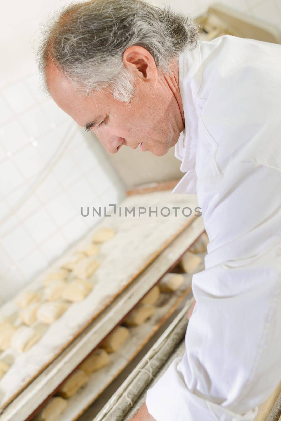 Baker preparing baguettes for the oven