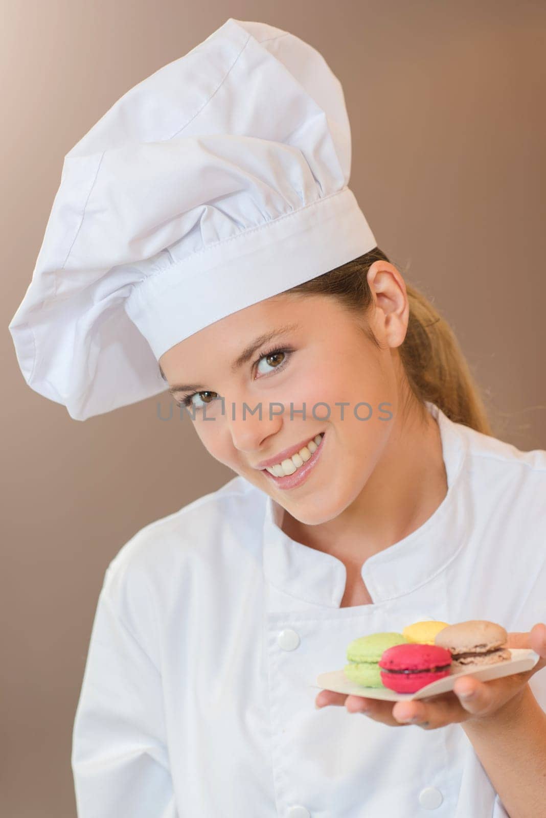 Bakery worker holding some macaroons