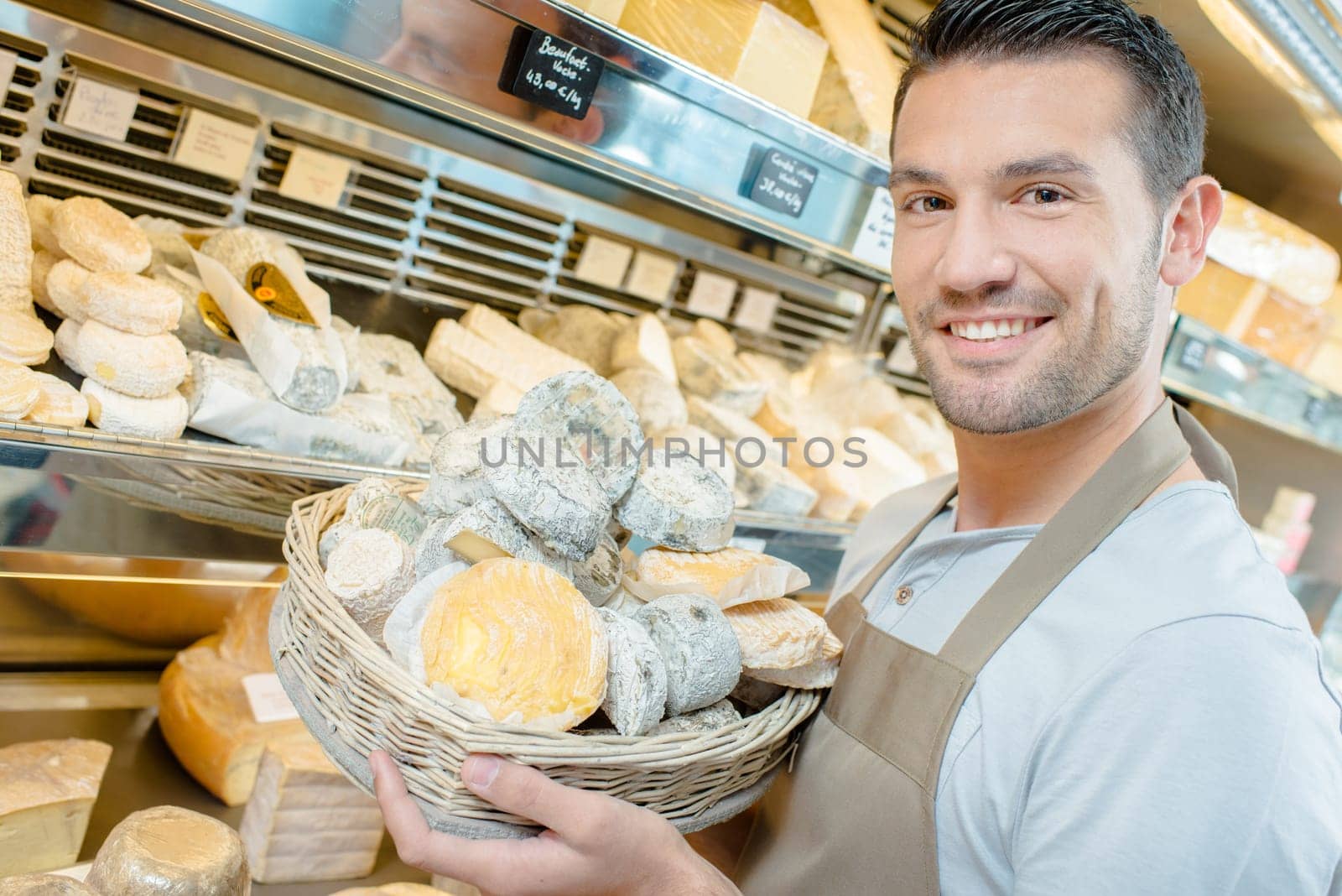 Man stocking the shelves in a cheese shop
