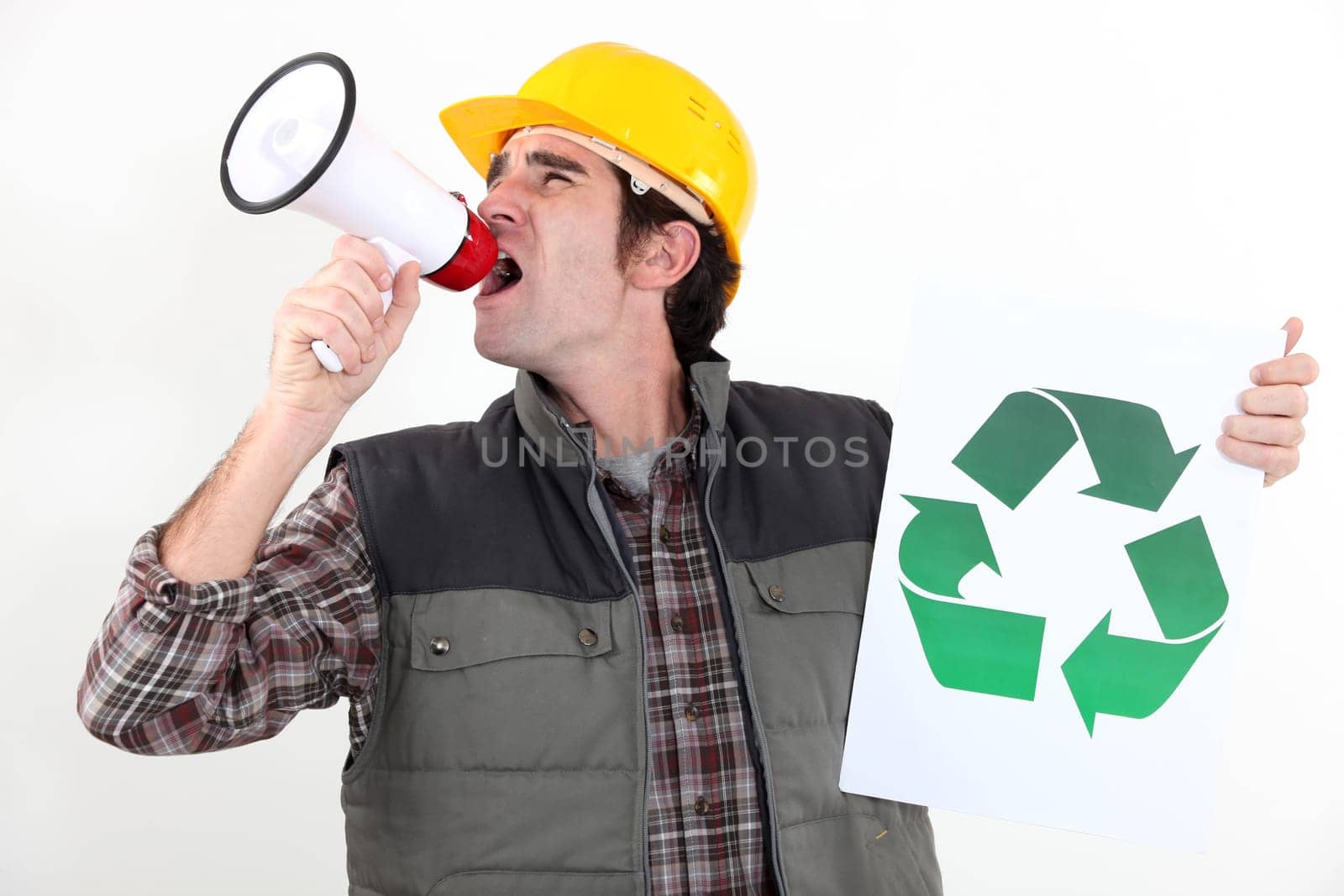 craftsman holding a recycling label and shouting through a megaphone