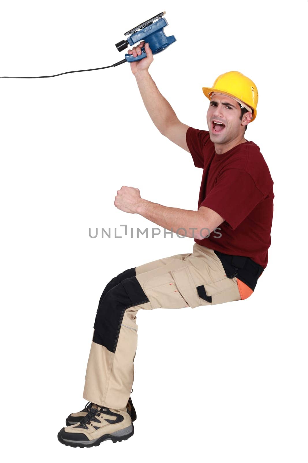 joyful carpenter holding sander machine