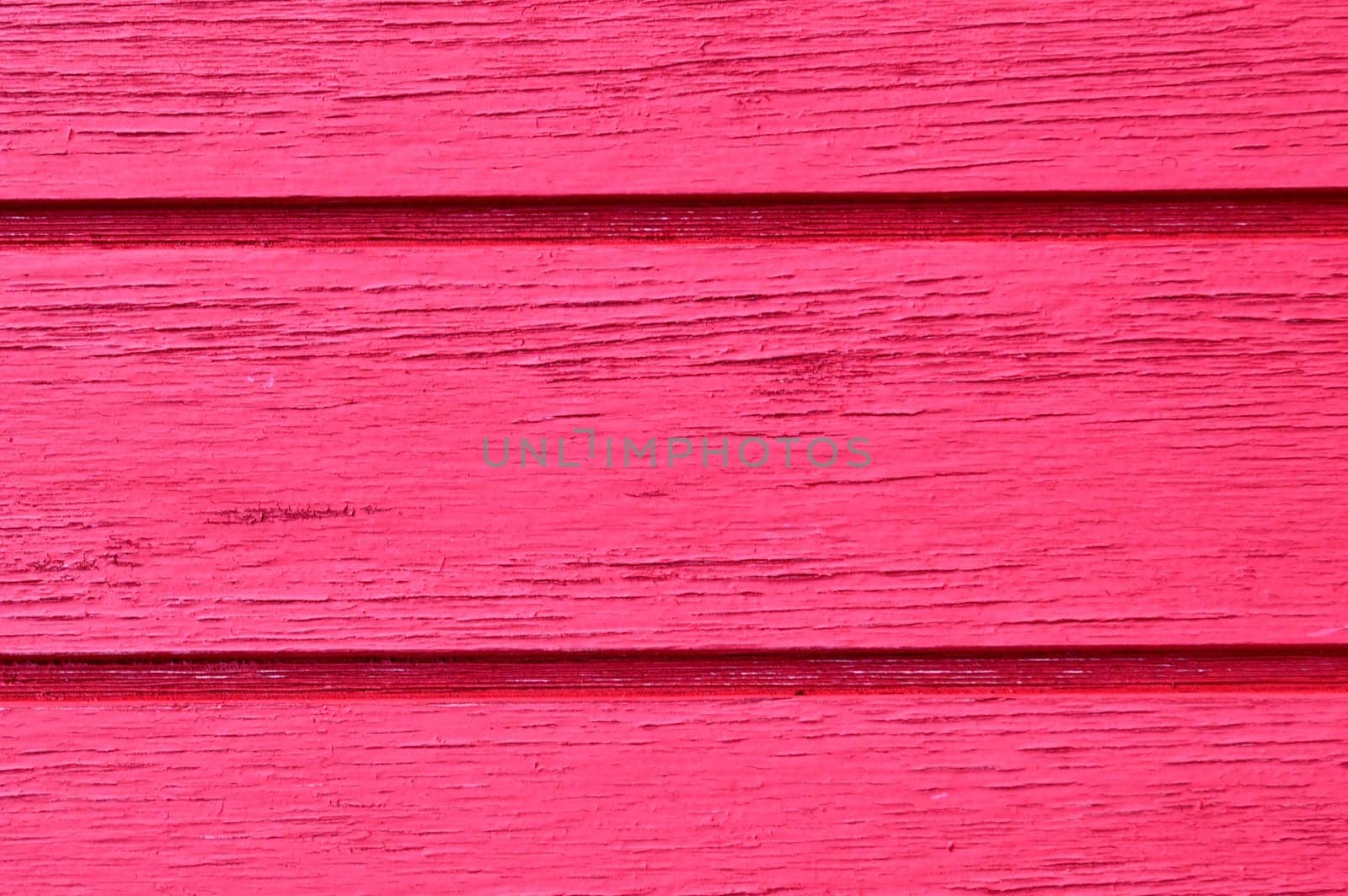 Wood slats running horizontal, distressed, chipping paint job, in hot pink.