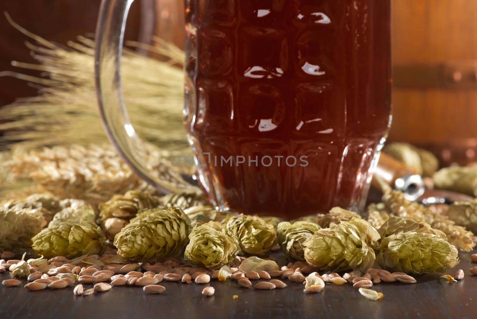 Beer glass with beer barrels,wheat,barley,hops and malt