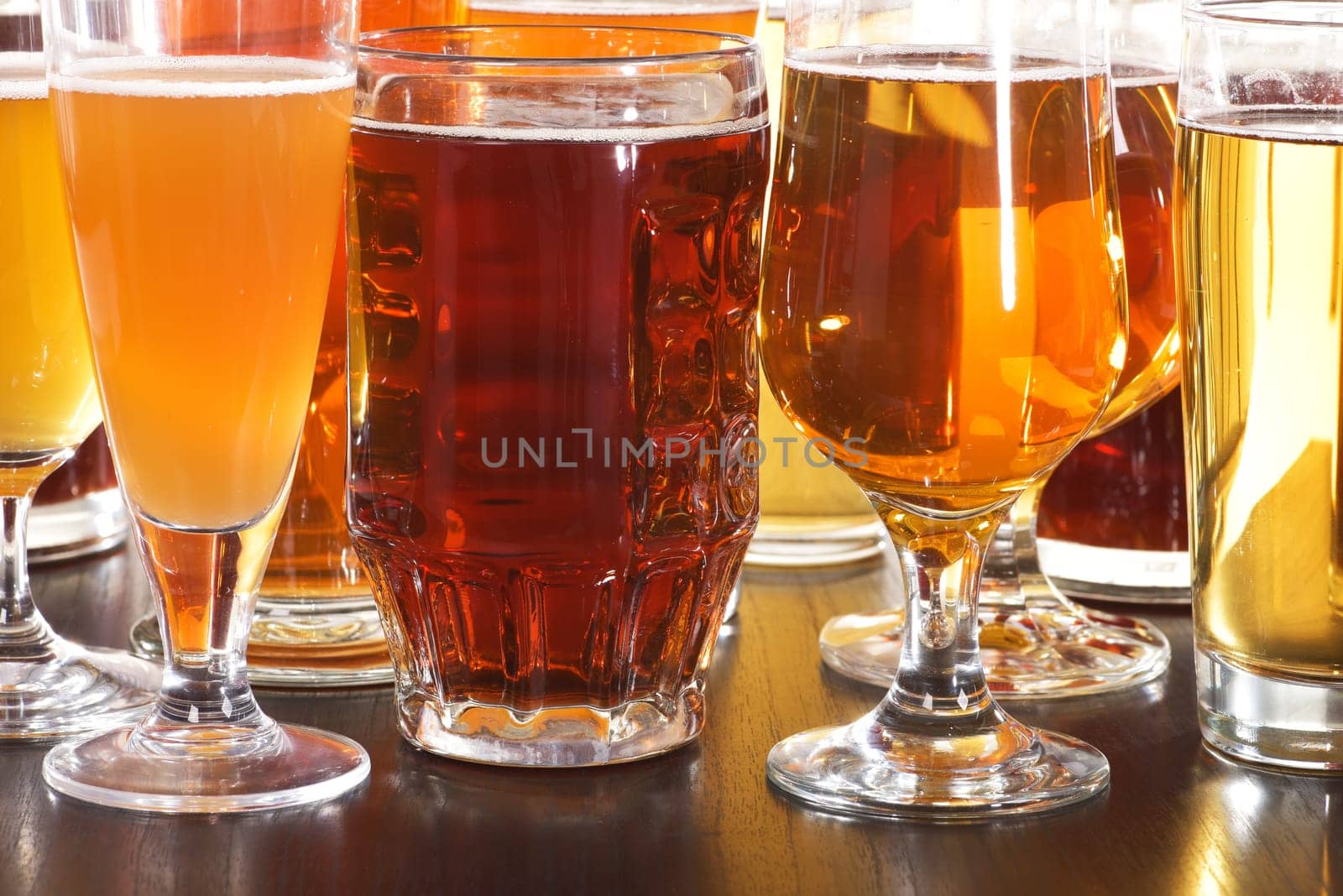 Many different beer glasses with different beer from all over the world
