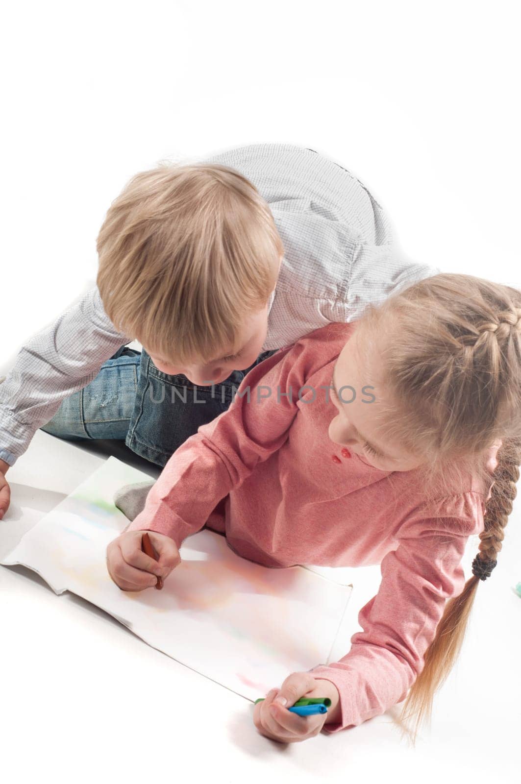 Little girl and boy painting. Shallow depth of field. Focus on the picture
