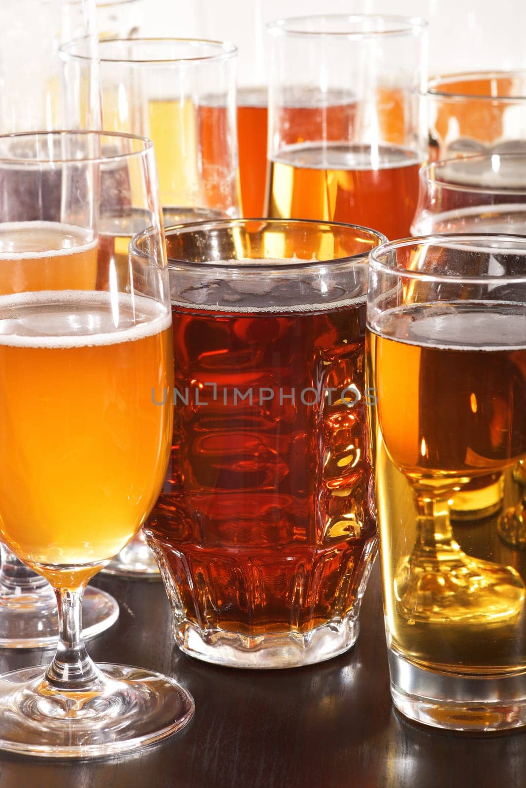 Many different beer glasses with different beer from all over the world