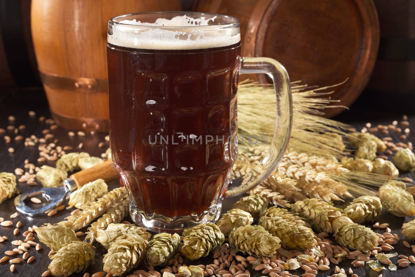 Beer glass with beer barrels,wheat,barley,hops and malt