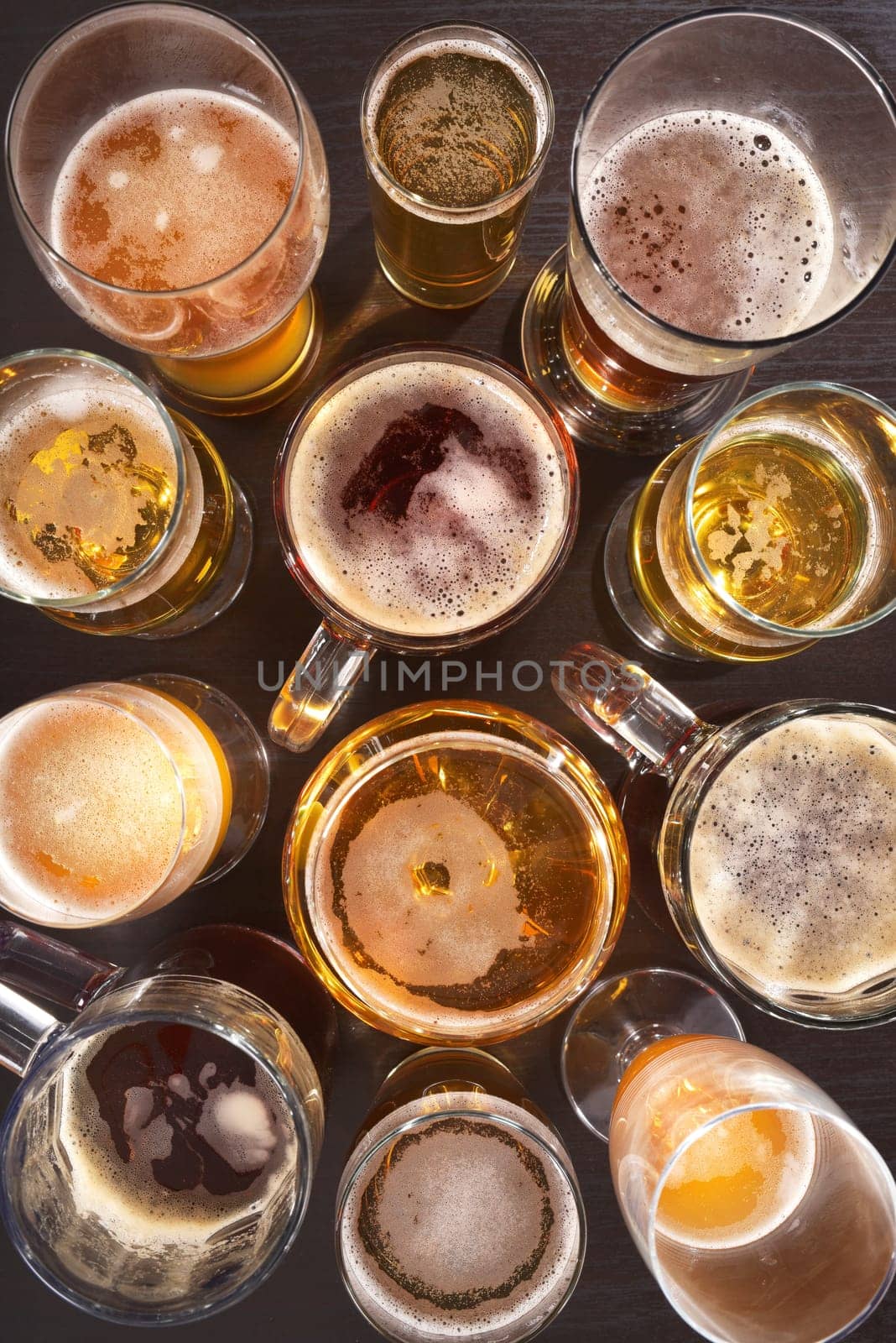 Many different beer glasses with different beer from all over the world