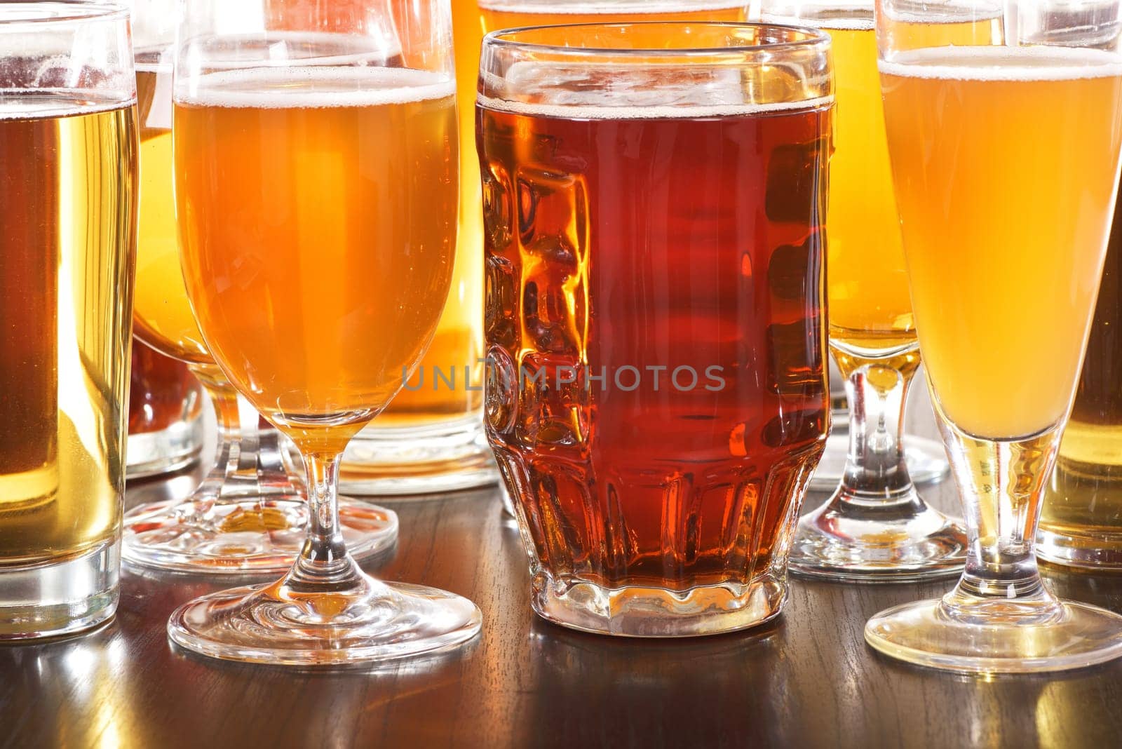 Many different beer glasses with different beer from all over the world