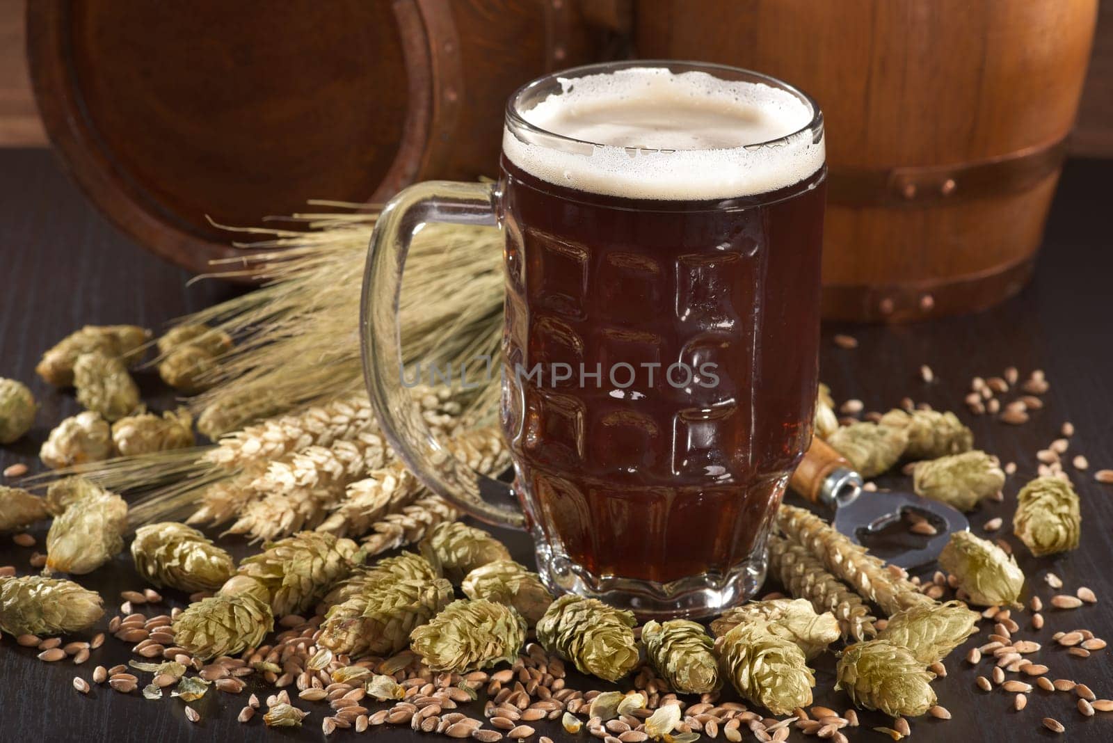 Beer glass with beer barrels,wheat,barley,hops and malt