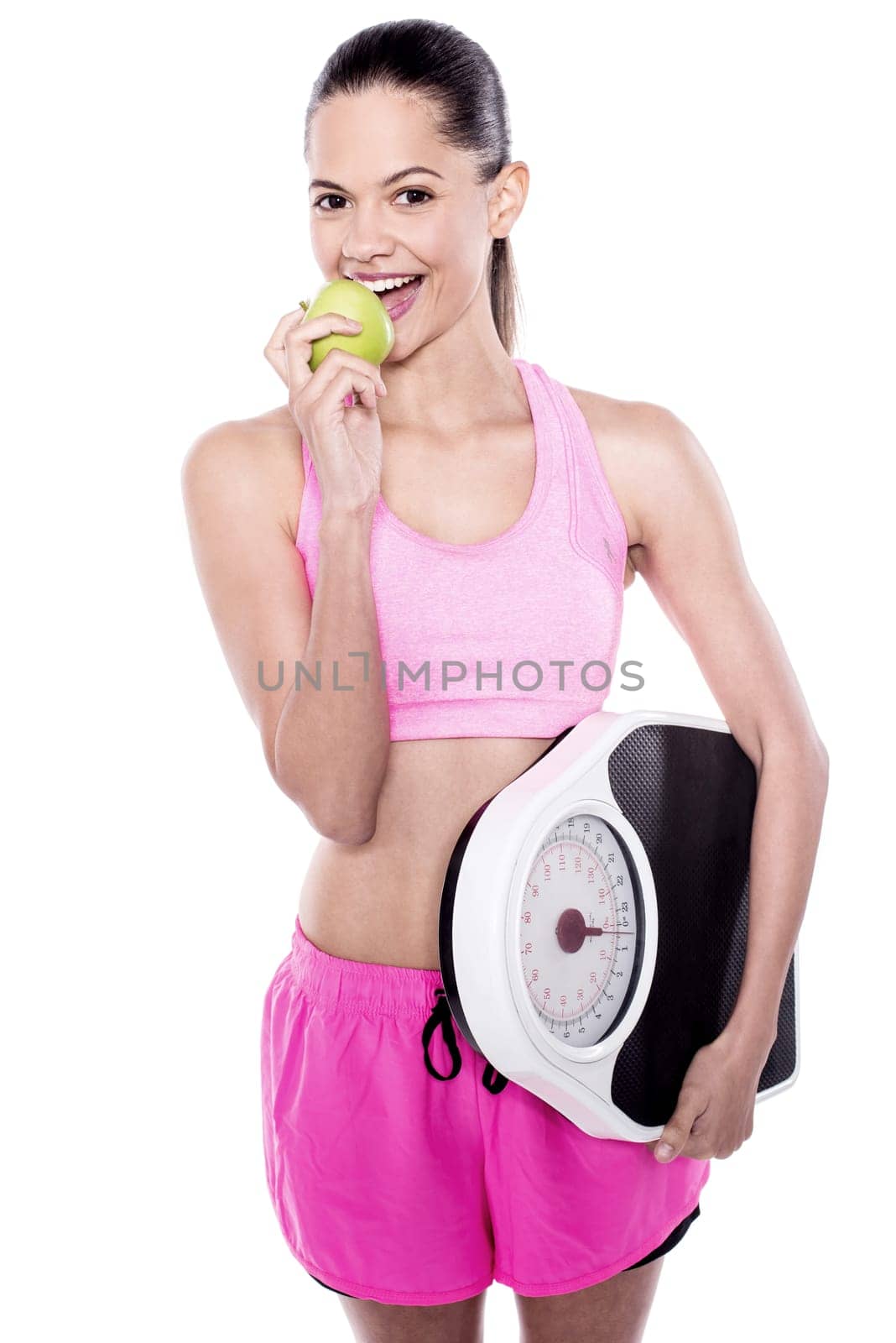 Young trainer eating green apple