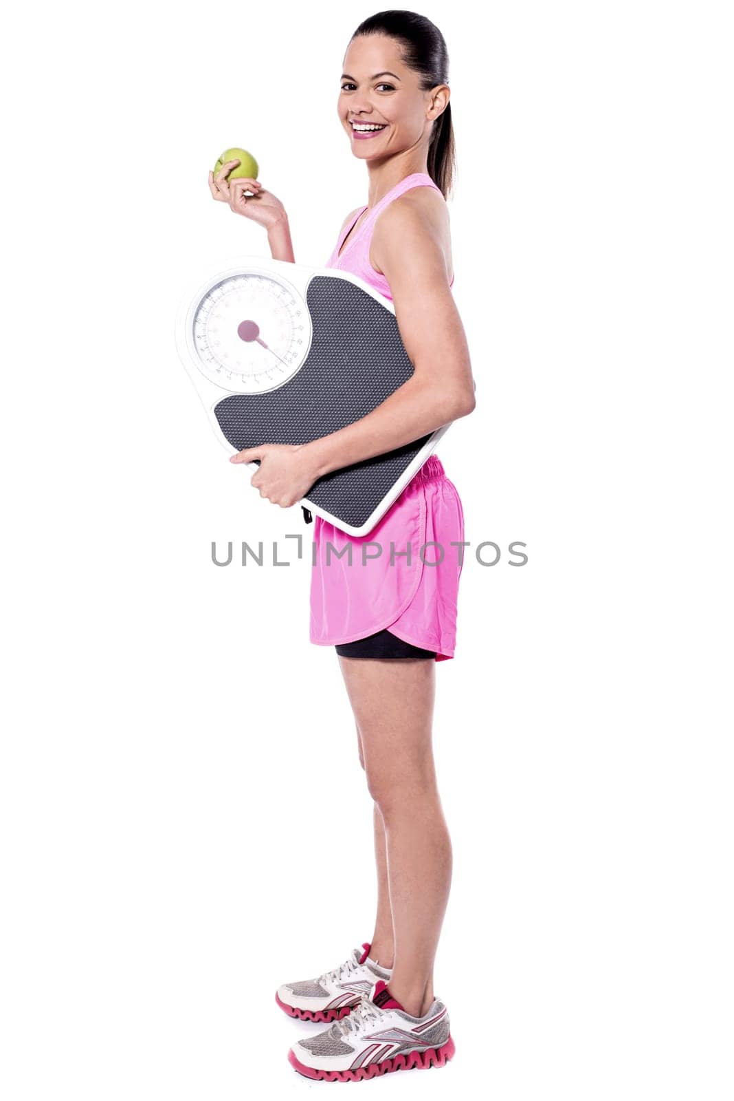 Side pose of lady holding weighing scale