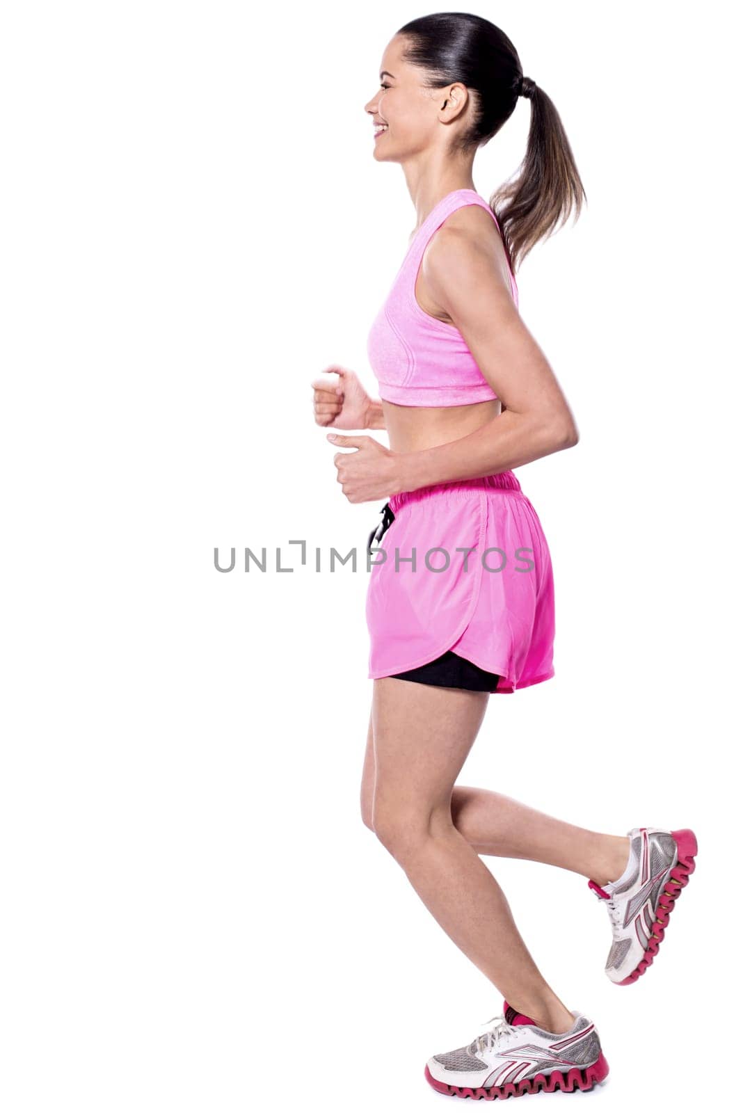 Young fitness woman running over white background