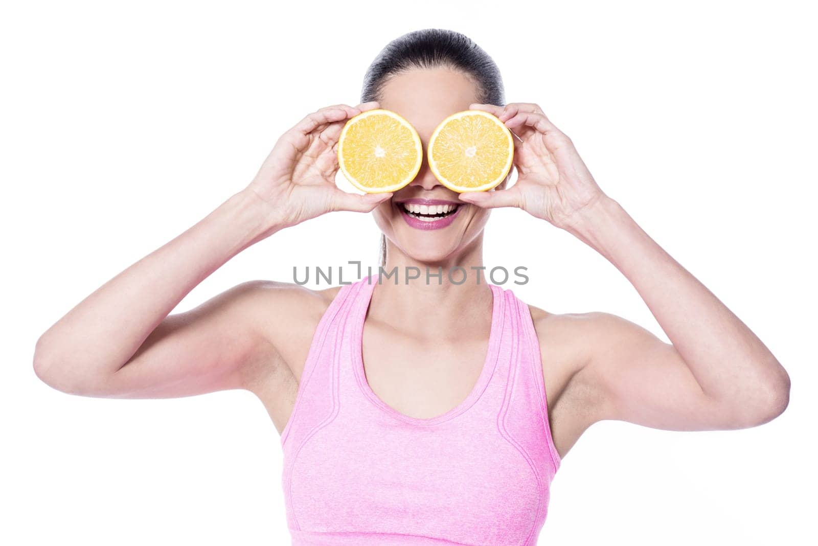 Young trainer putting sliced orange on eyes