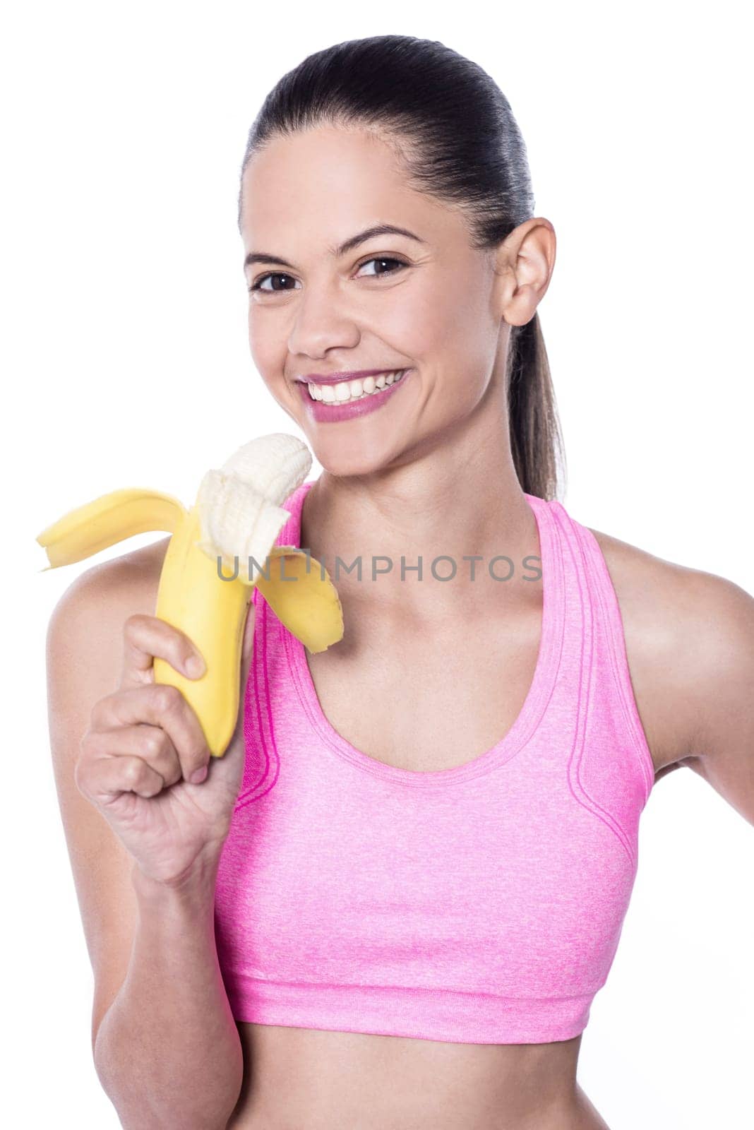 Slim fit woman eating banana
