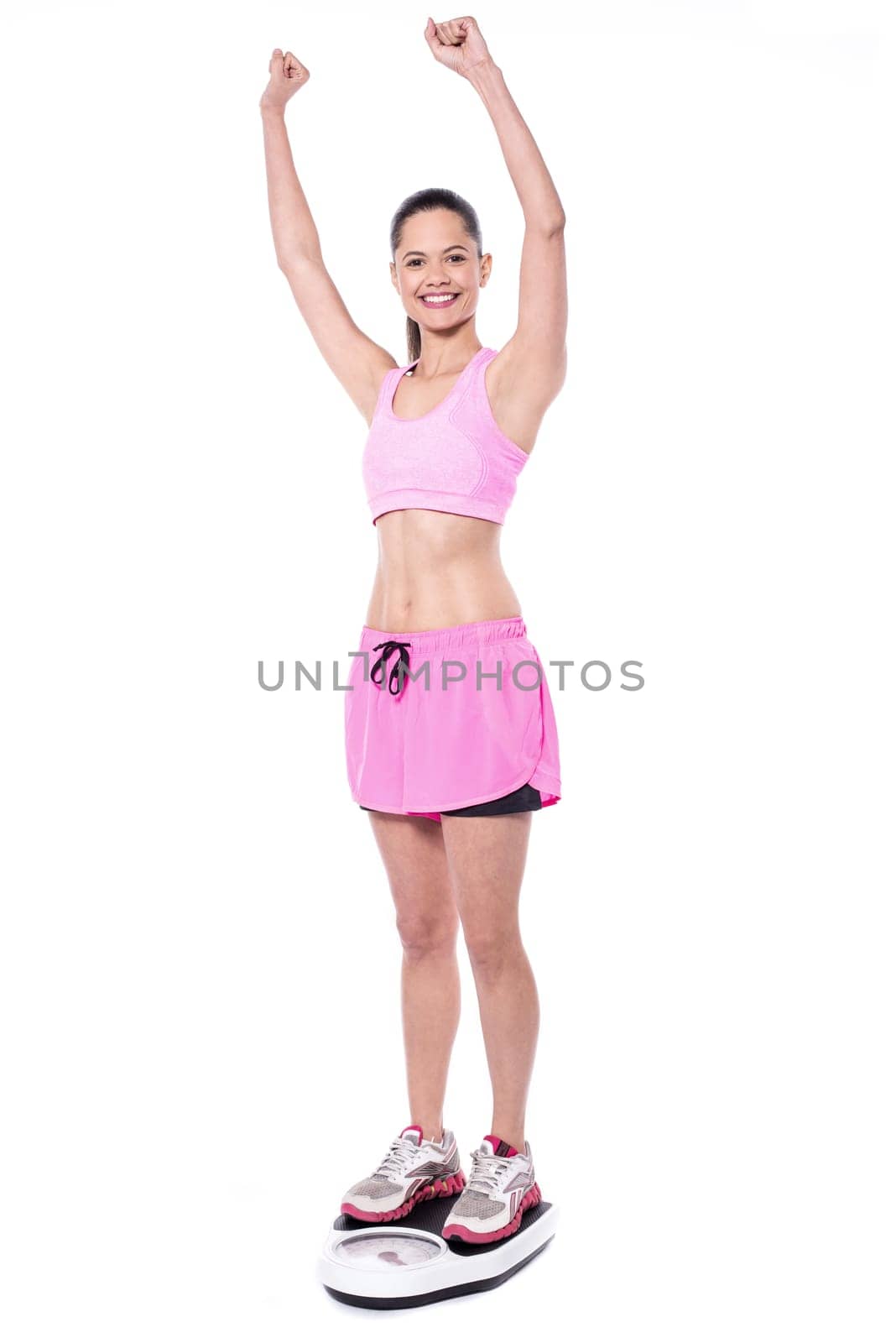 Sporty woman measuring her weight
