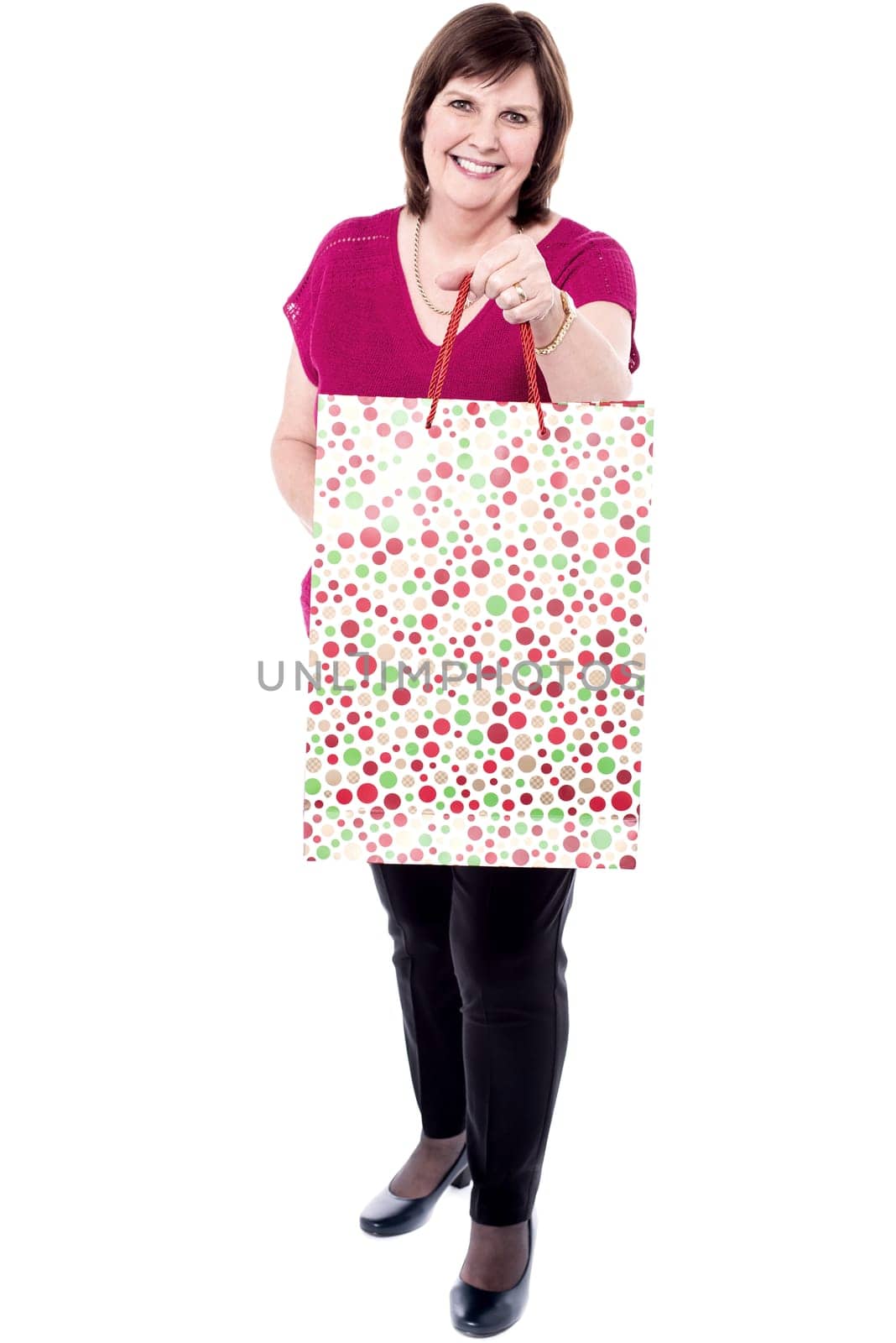 Senior woman with shopping bags. Isolated over white background.