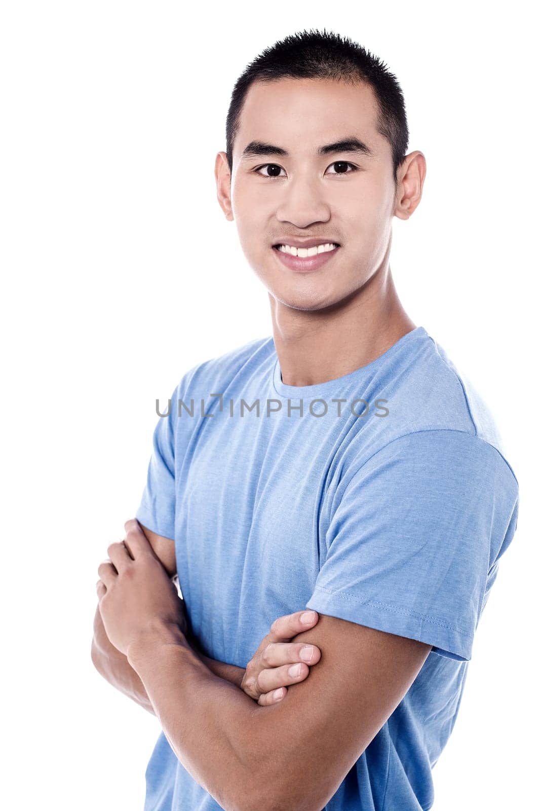 Casual young man looking at camera with arms crossed
