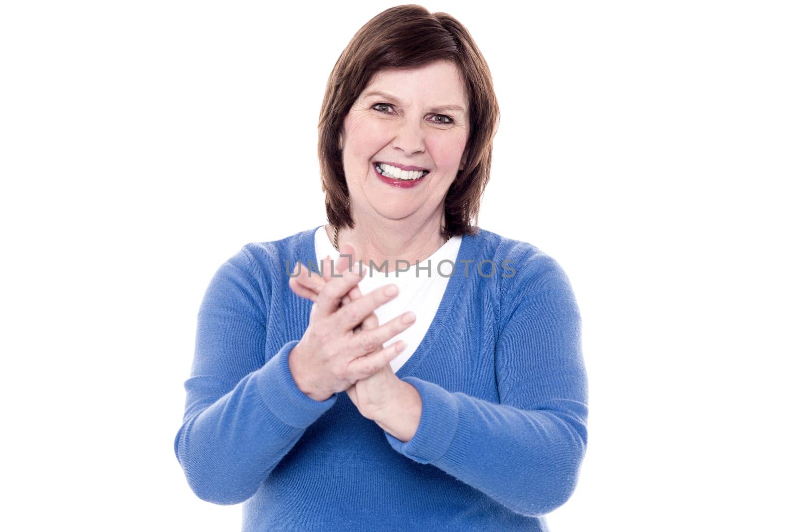 Female senior cheerfully claps her hands over white