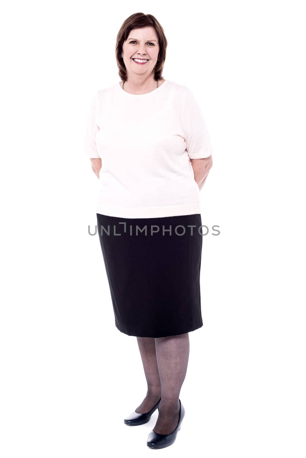 Full length image of senior woman folded hands at back