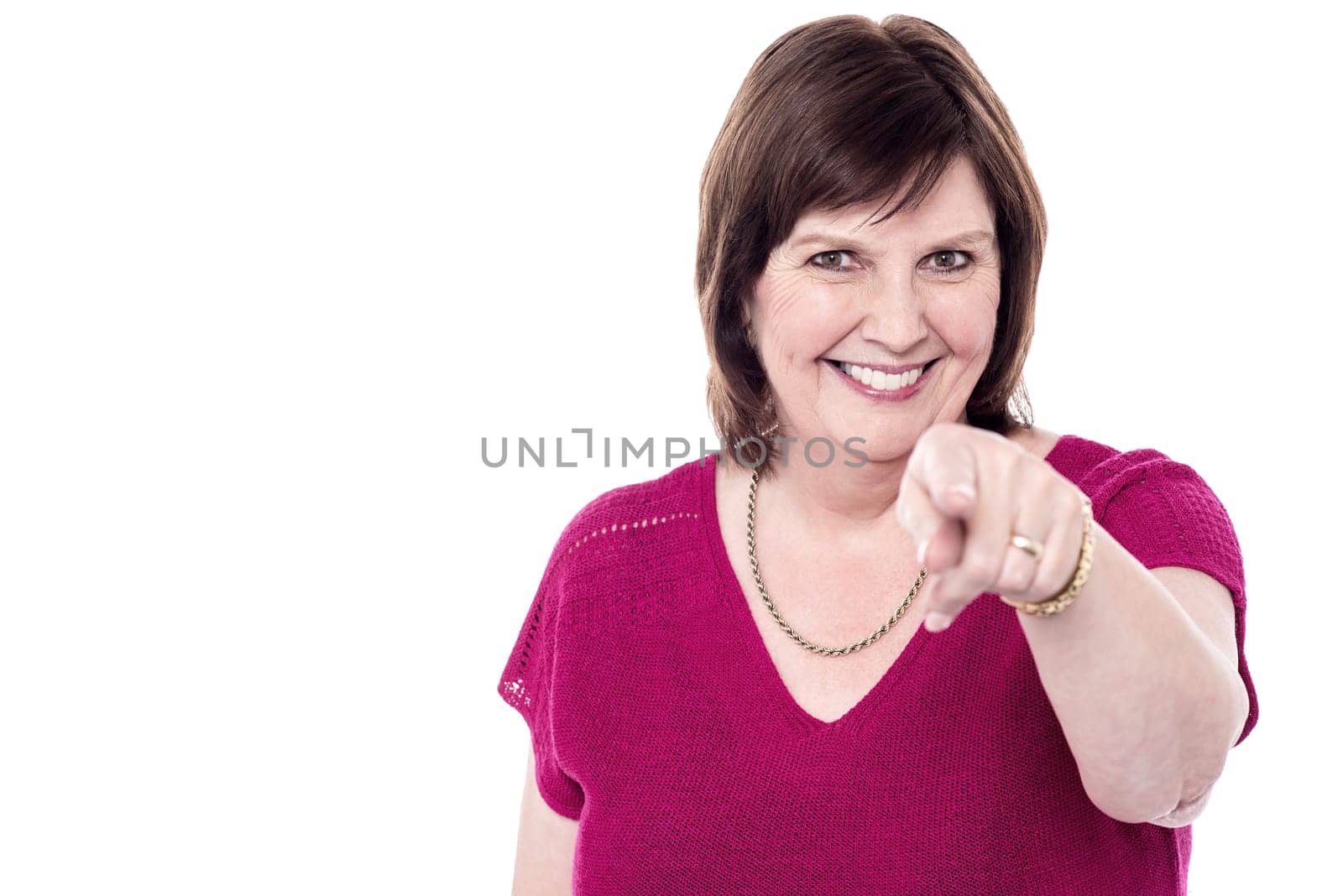 Cheerful senior woman pointing to you