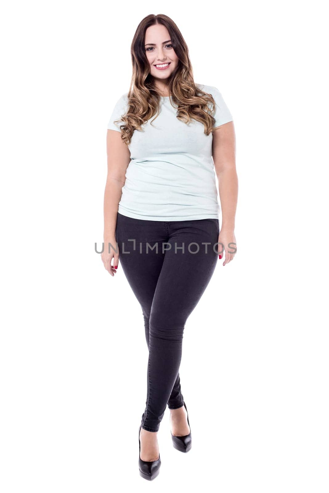 Stylish woman standing with crossed leg over white