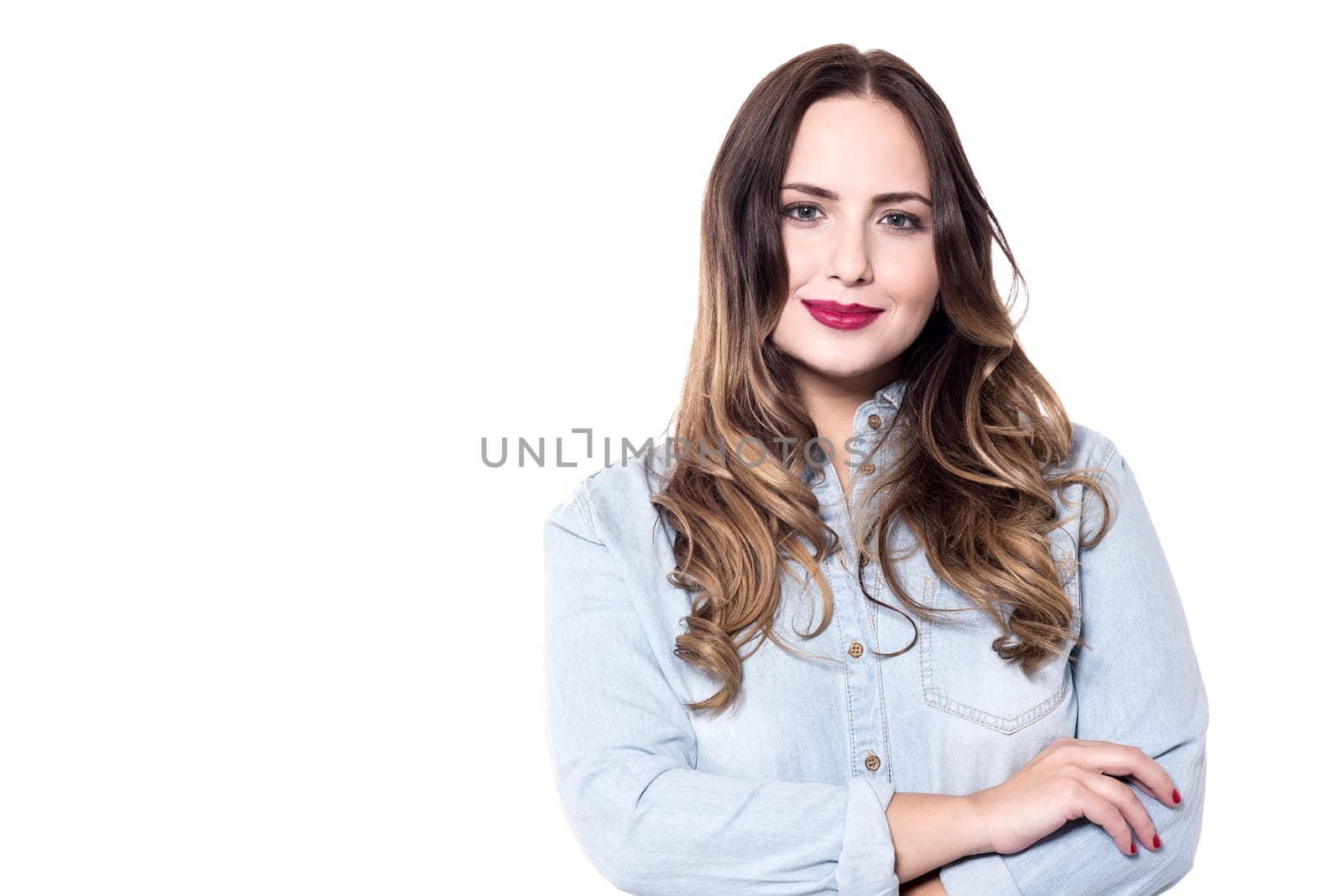 Beautiful young woman posing with folded arms.