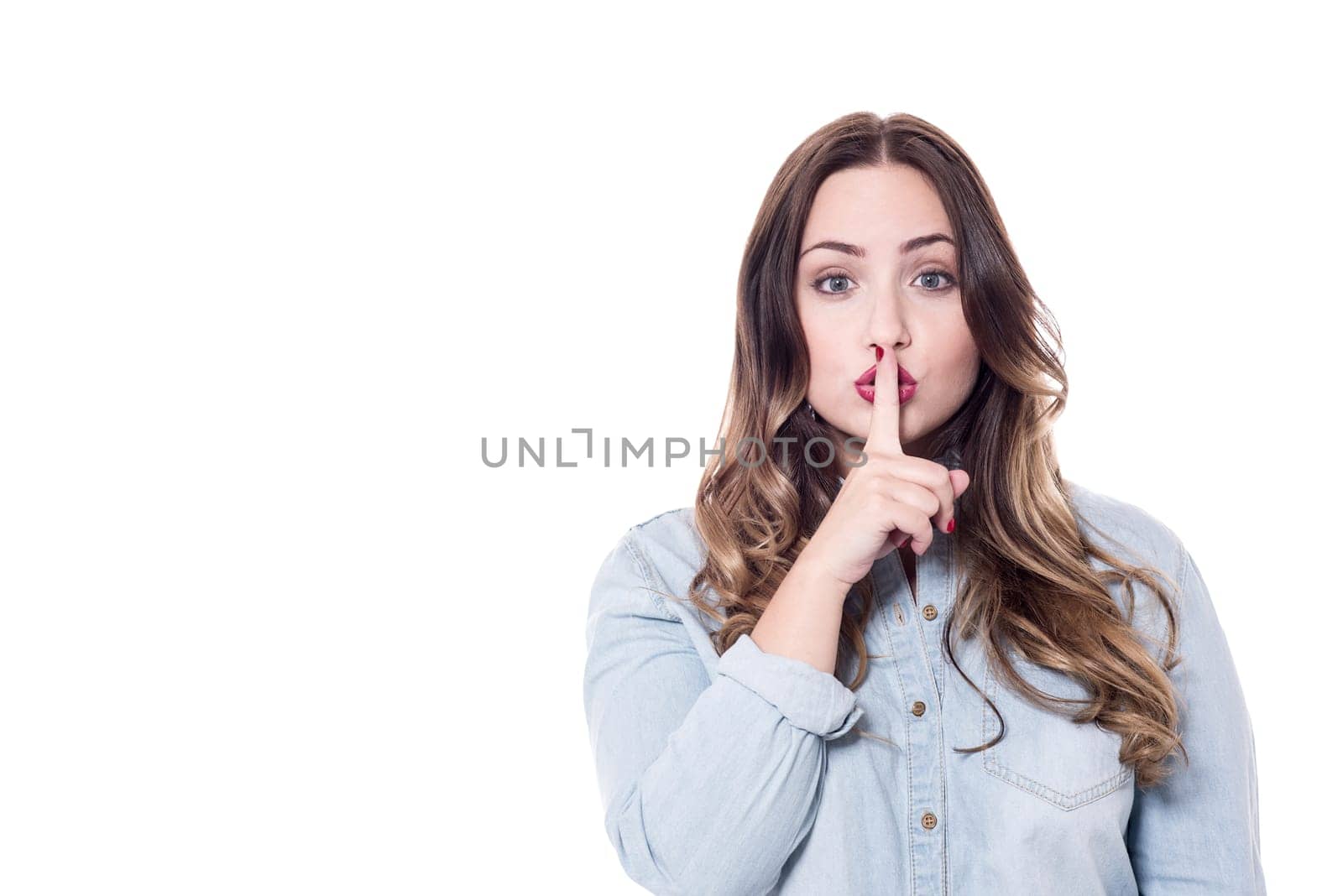 Portrait of pretty woman with finger on lips