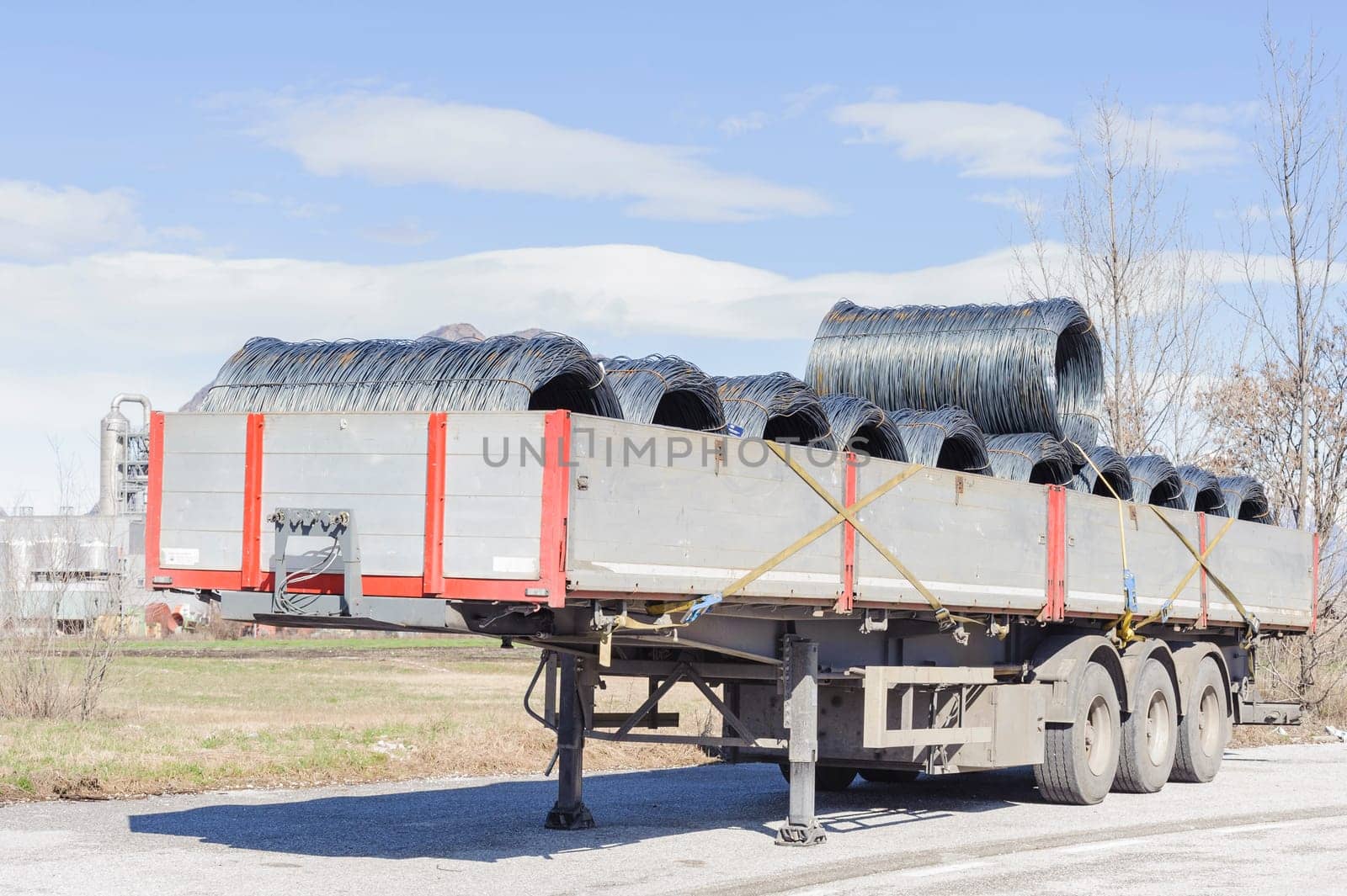 Steel Wire Rolls. Steel wire rolls industrial construction products on transport trailer.