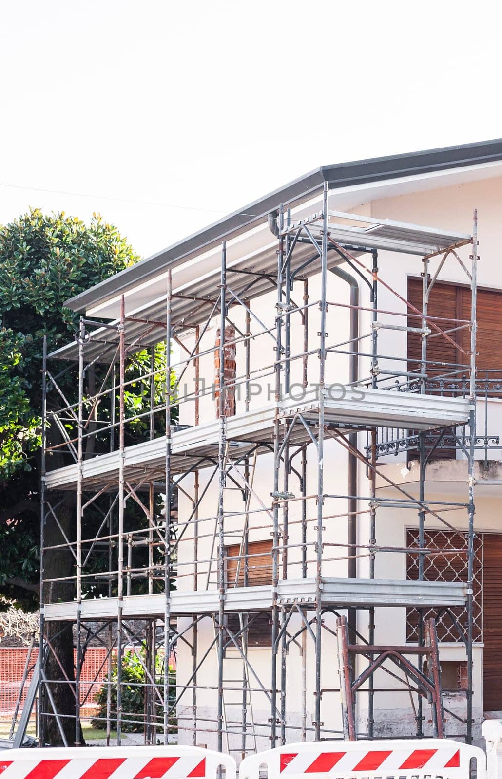 House for renovation with the scaffolding for bricklayers