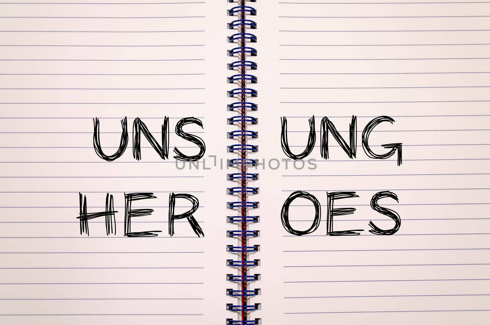 Unsung heroes text concept write on notebook